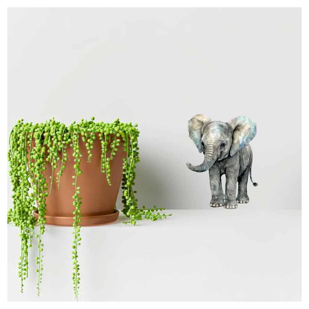 Artrooms elephant decal on a wall beside a potted plant, perfect for living room and bedroom decor.