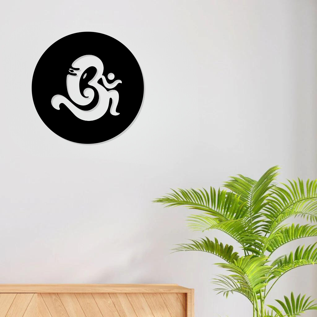 Om Ganesha metal wall art round black wall hanging above indoor plant – spiritual decor for living room or temple