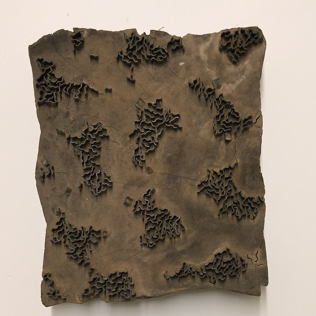 Rustic Indian wooden printing block with hand-carved abstract foliage and wave-like pattern