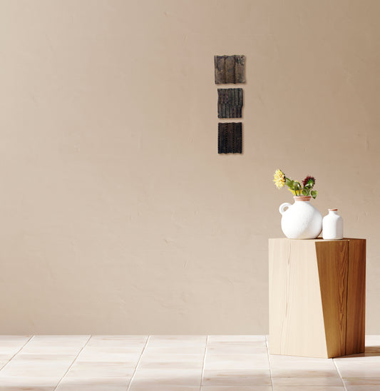 Wooden printing blocks displayed as wall décor in a living room