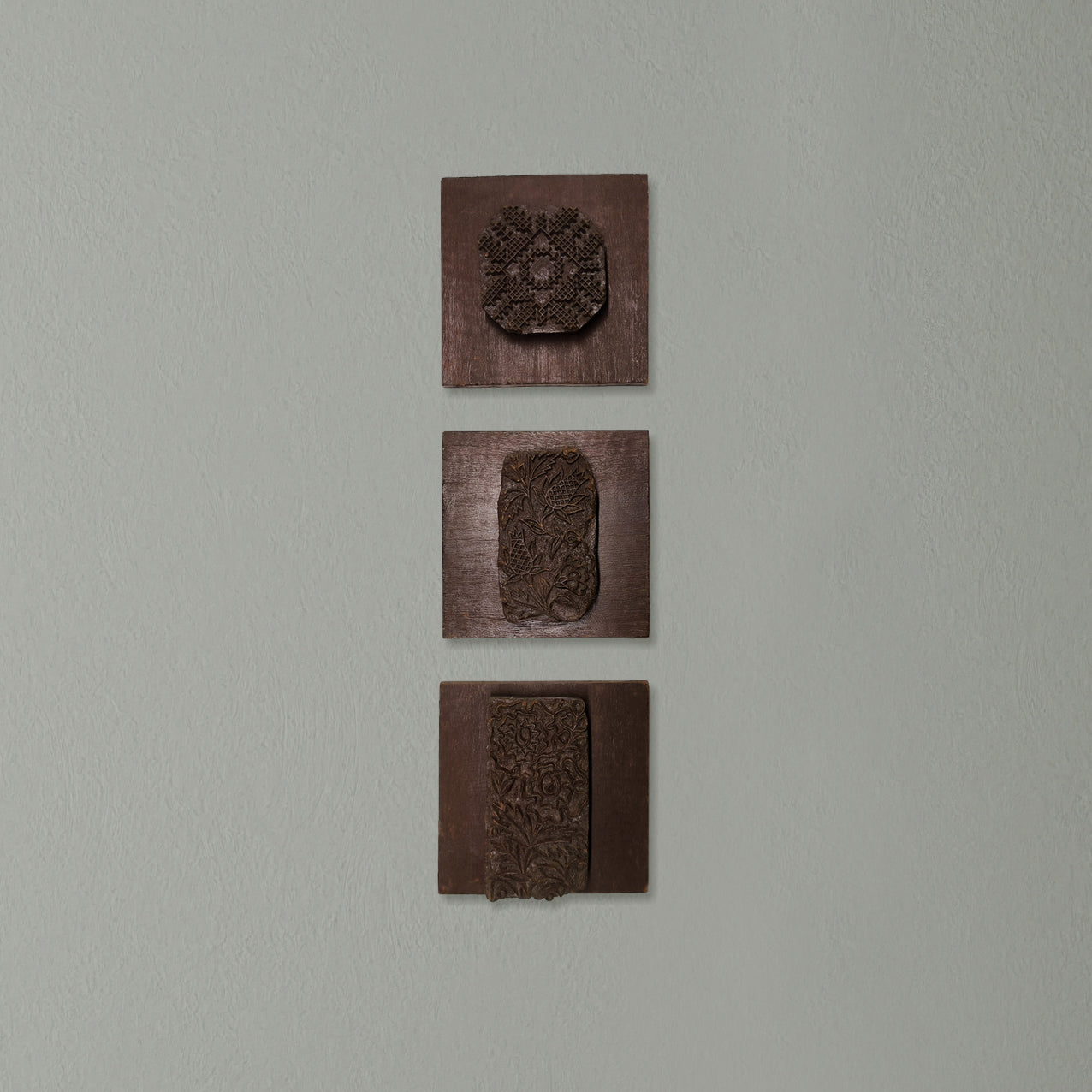 Vintage Indian wooden printing blocks displayed as rustic wall décor
