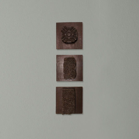 Vintage Indian wooden printing blocks displayed as rustic wall décor