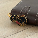 Black enamel rabbit brass bookmark clipped on brown leather notebook