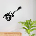 Black guitar silhouette metal wall art mounted on a light wall above a wooden cabinet