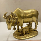 Brass Kamdhenu cow and calf idol with engraved detailing, close-up angle view