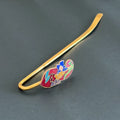 Brass floral bookmark with red enamel and multicolor flowers on black background