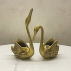 Brass swan pair decor showpiece with intricate feather detailing, angled view