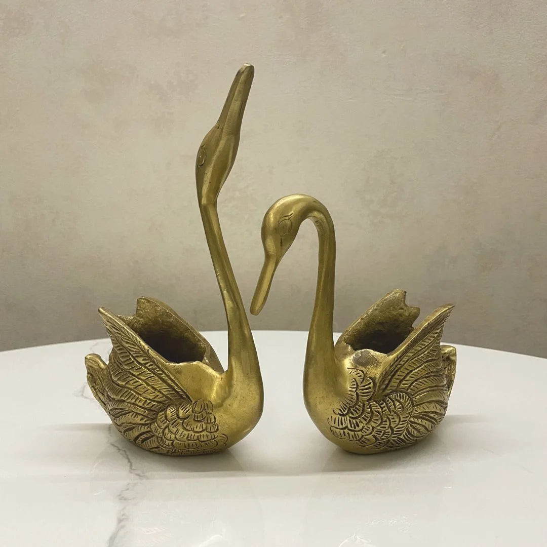 Brass swan pair decor showpiece with intricate feather detailing, angled view
