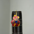 Brass teddy bear bookmark with red enamel and blue heart on leather journal spine
