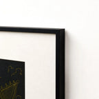 Close-up of black metal frame corner with cream matting border
