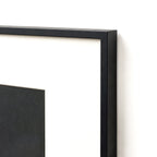 Close-up of black metal frame corner with cream matting border
