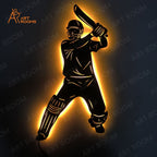Metal cricket wall art illuminated with warm light, featuring a batsman in action. Ideal for home decoration.