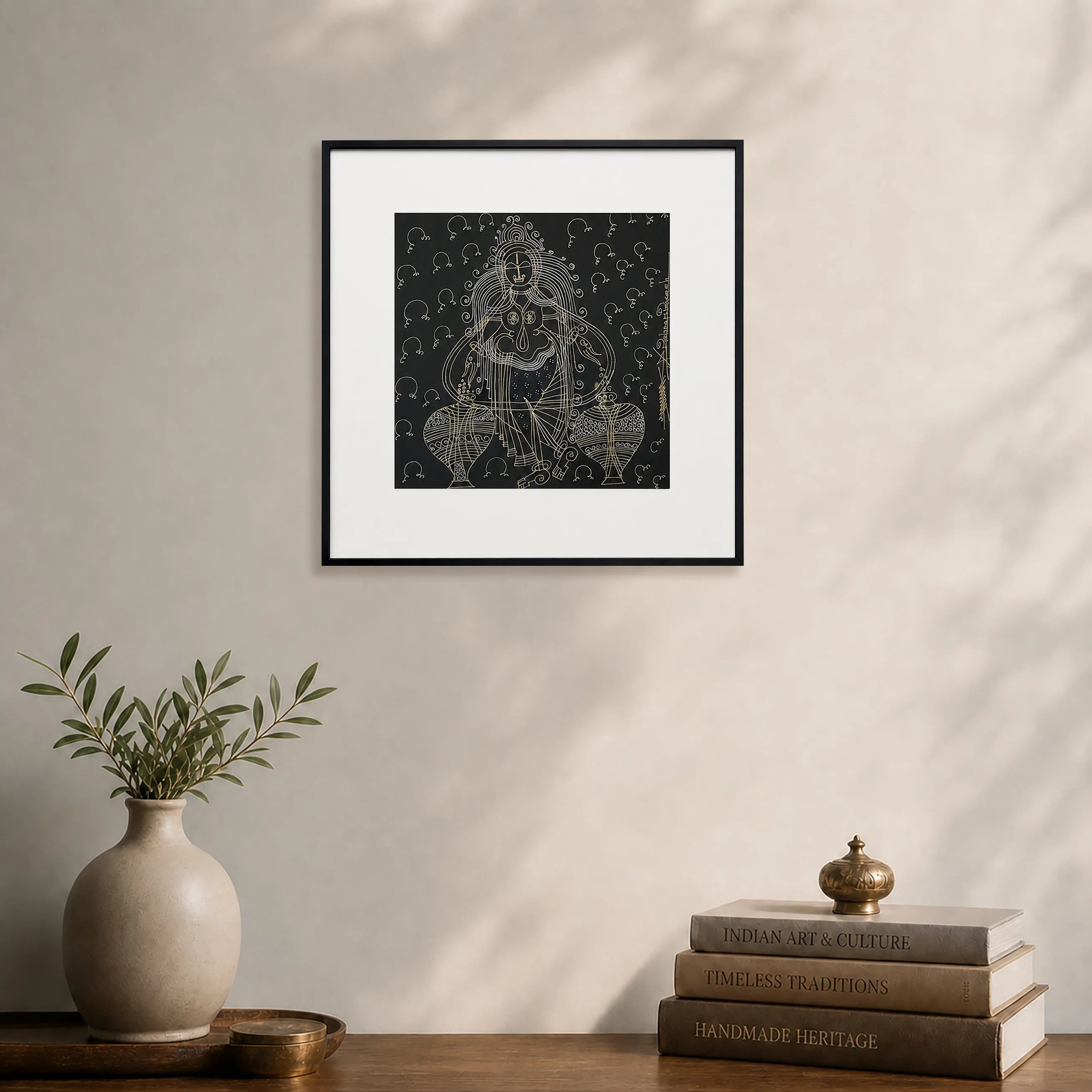 Framed Goddess Laxmi Surpur art painting hanging above a console table on a wall
