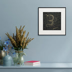 Framed Om Shree Namah Surpur art painting hanging above a console table on a wall
