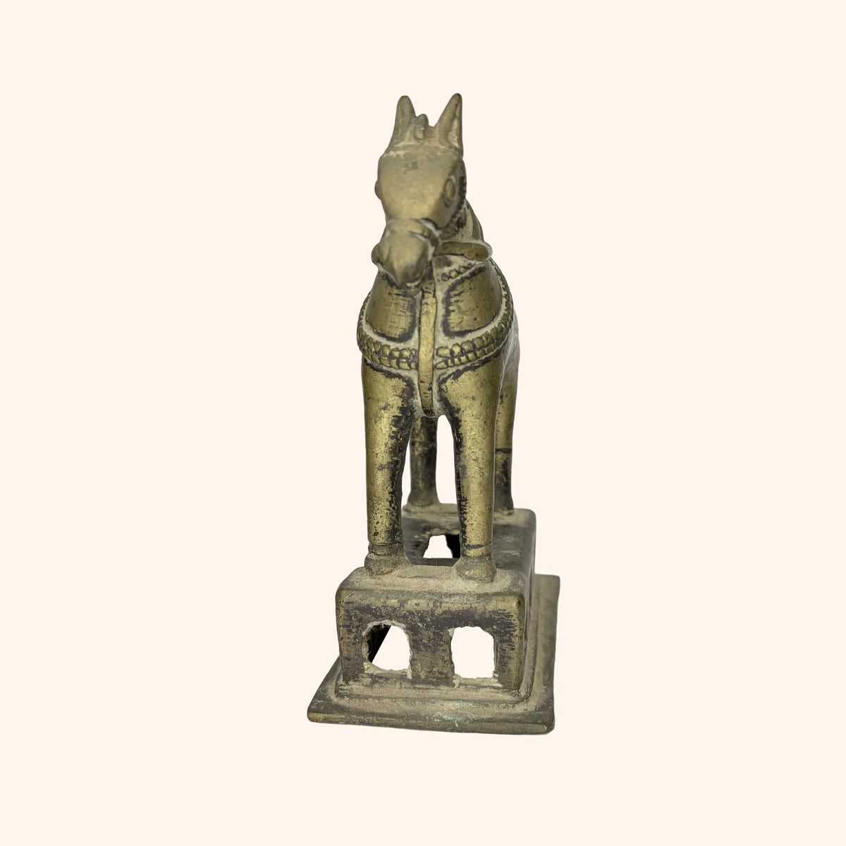 Front-facing close-up of the antique brass horse's head and bridle
