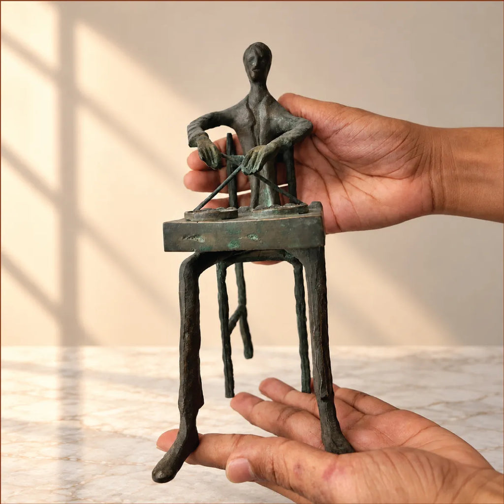 Hands holding the 21 cm antique brass tribal drummer figurine to show its scale
