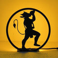 Hanuman Table Lamp glowing warm LED light on table, front view