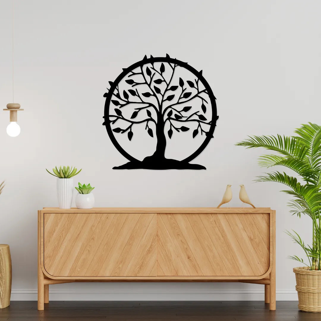 Tree of life round metal wall art above wooden sideboard