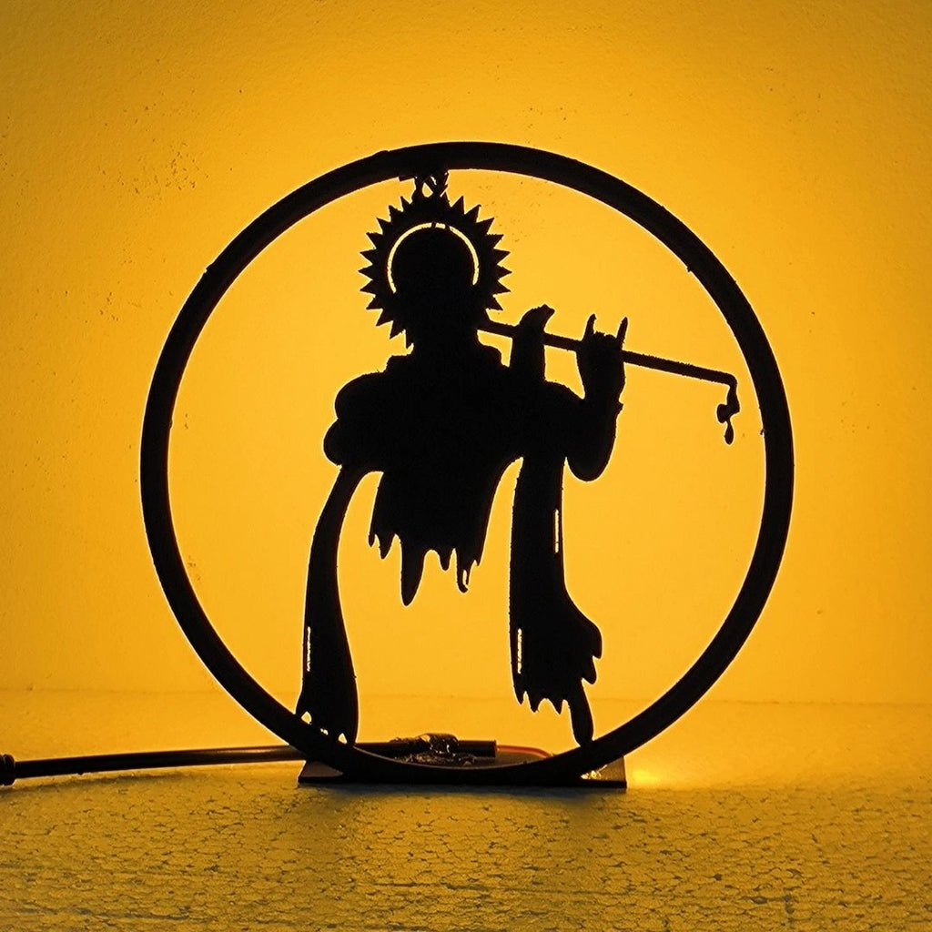 Lord Krishna Table Lamp glowing warm LED light on table, front view