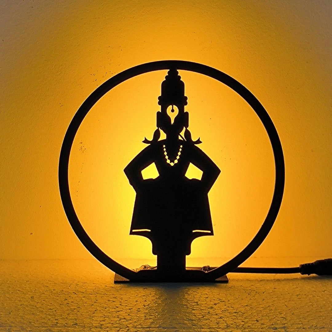 Lord Vitthal Table Lamp glowing warm LED light on table, front view