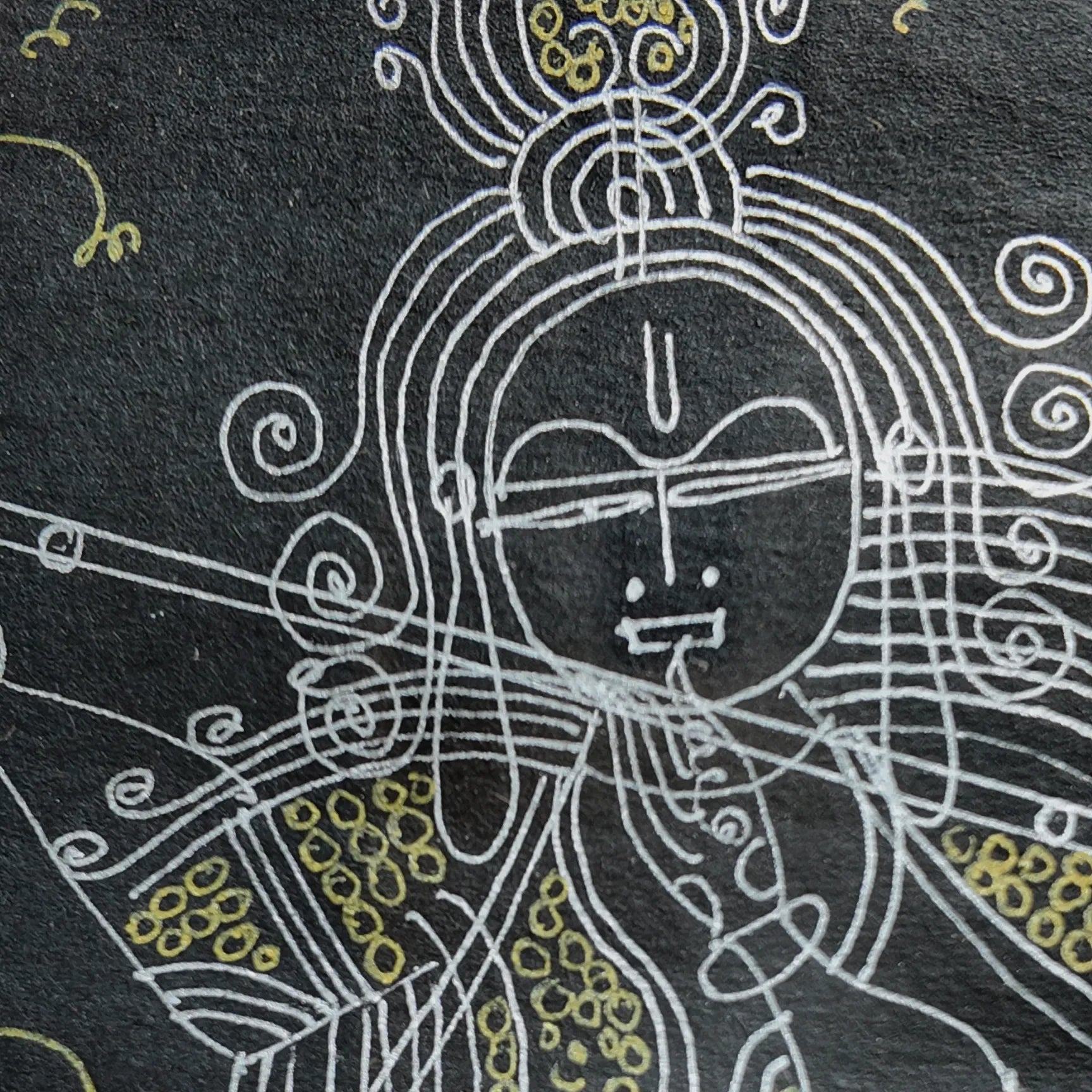 Macro shot of intricate hand-drawn ink linework on Krishna artwork
