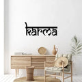 Matte black metal “Karma” wall art nameplate 24x10 inch displayed above console table