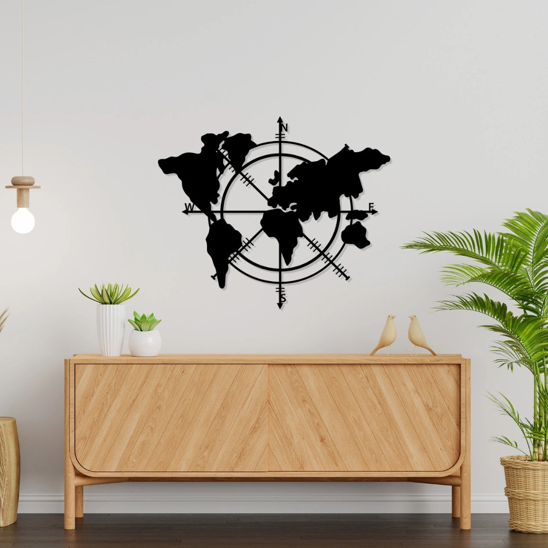 Matte black metal world map wall art with compass design displayed above wooden sideboard