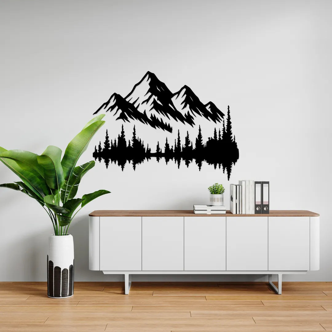 Mountain forest metal wall art above white sideboard with plant