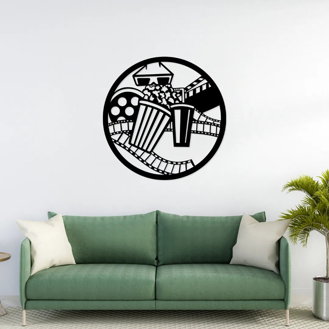 Movie theme metal wall art with popcorn and film strip above green sofa