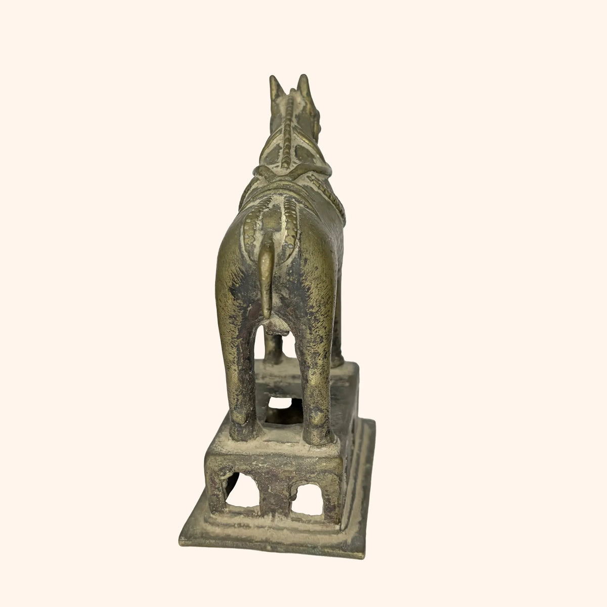 Rear view of the antique brass horse statue showing tail and harness detail
