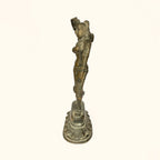 Side profile of the antique brass apsara statue showing the dance posture
