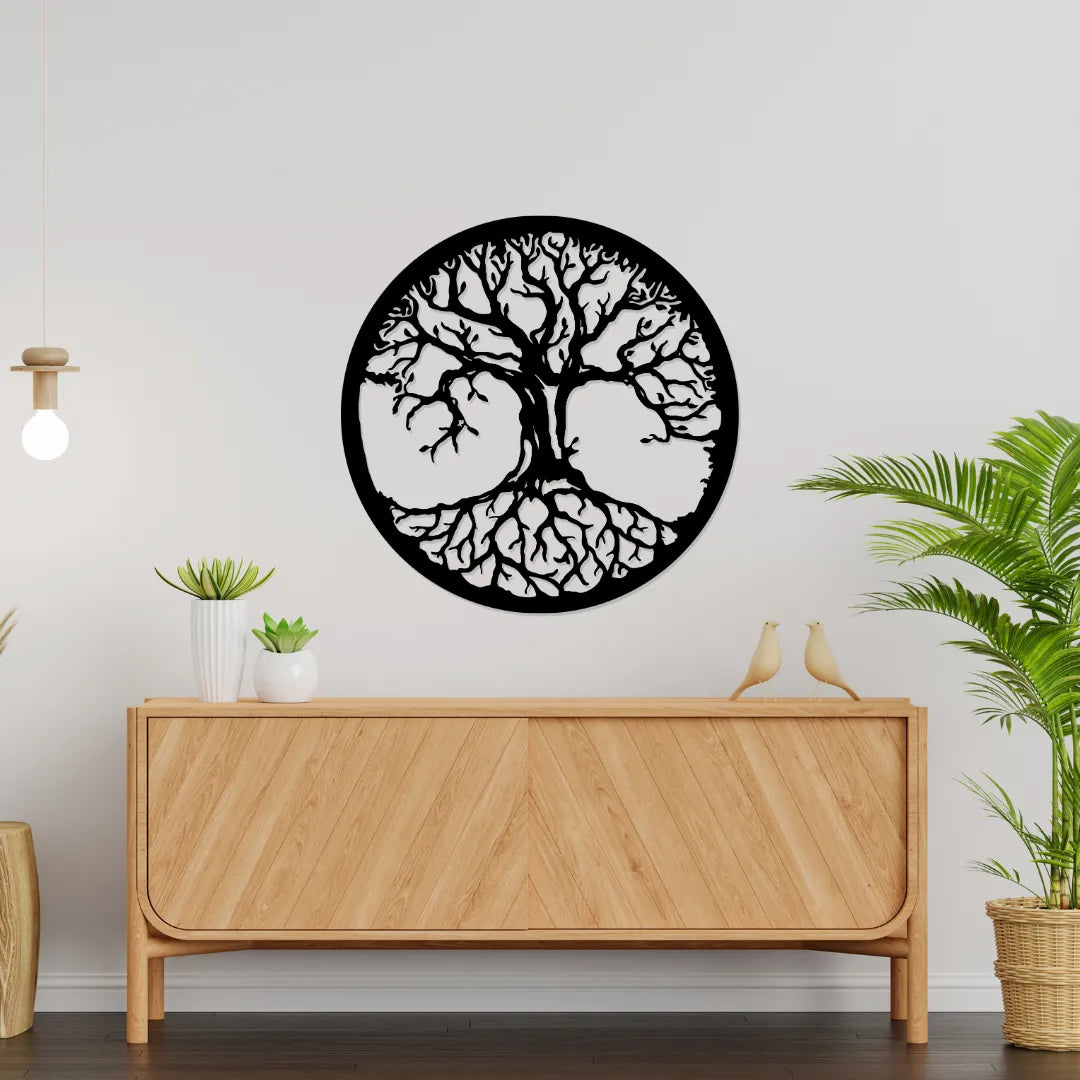 Tree of life round metal wall art above wooden sideboard
