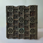 Vintage hand-carved wooden printing block with dot rosette lattice grid design
