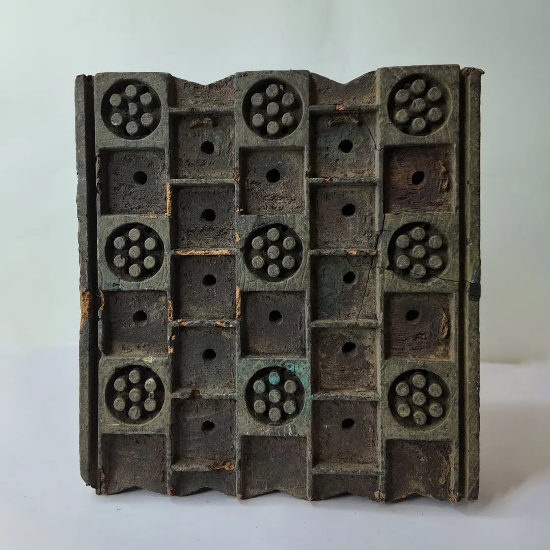 Vintage hand-carved wooden printing block with dot rosette lattice grid design

