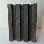 Vintage hand-carved wooden printing block with fluted groove column design

