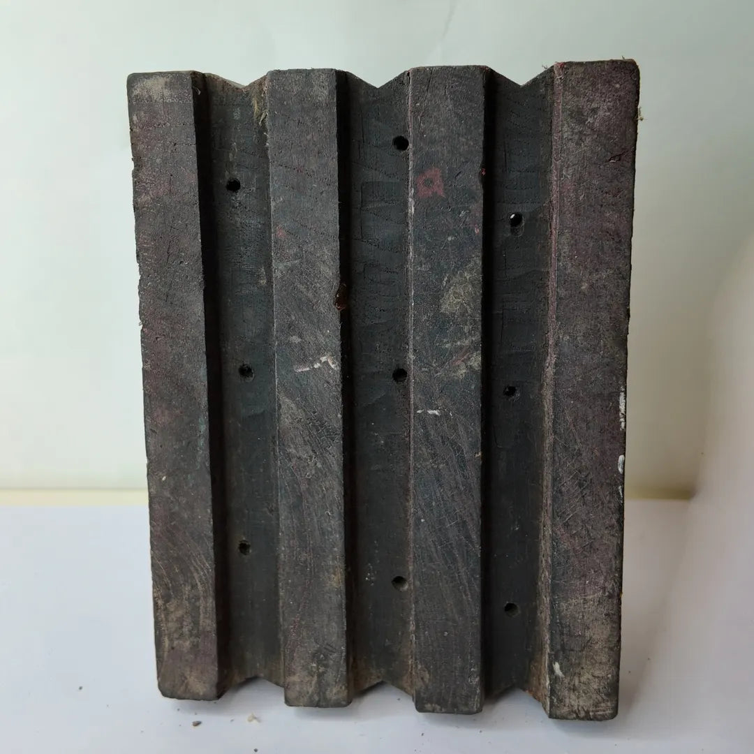 Vintage hand-carved wooden printing block with fluted groove column design
