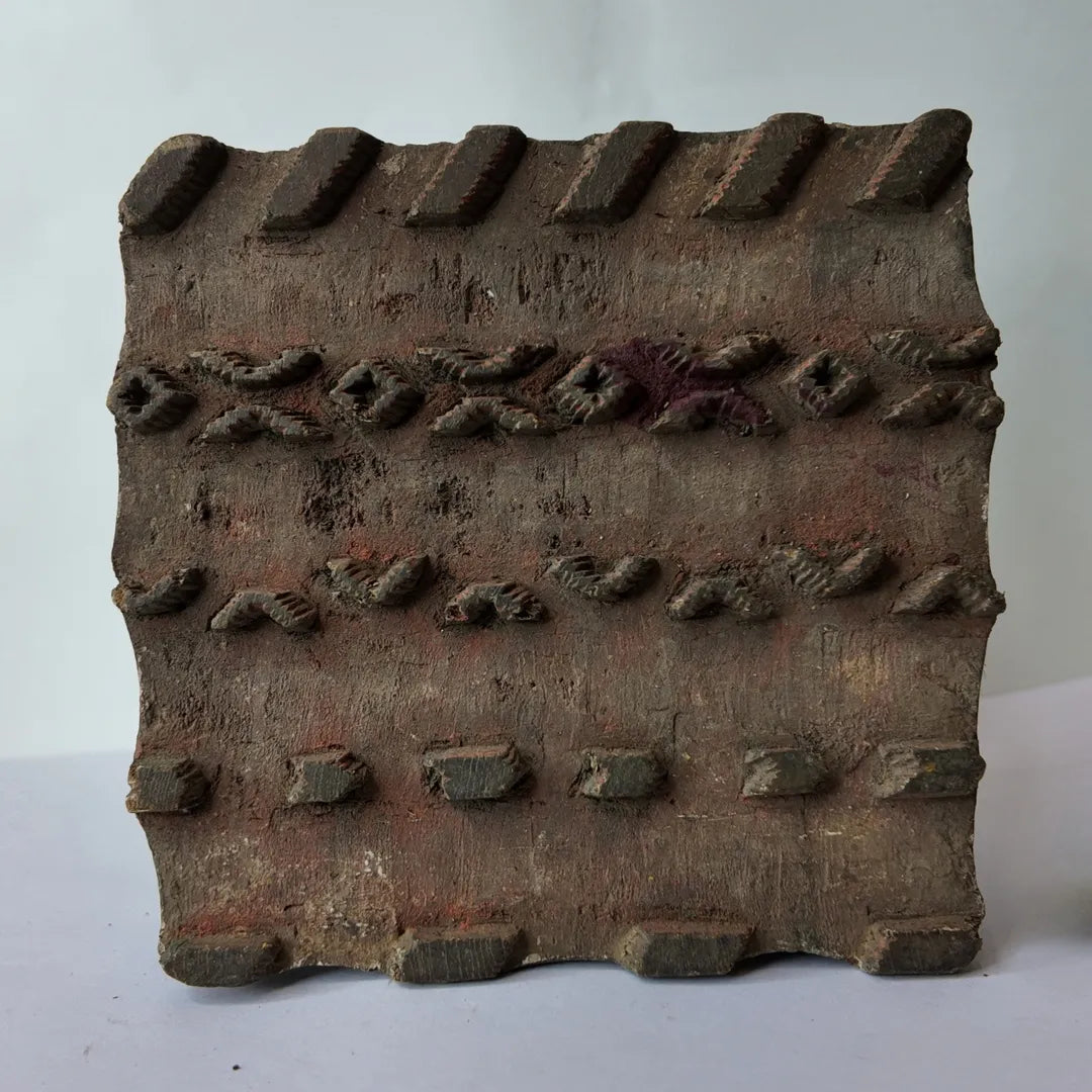Vintage hand-carved wooden printing block with mixed motif pigment border design
