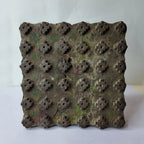 Vintage hand-carved wooden printing block with mossy fleur stud grid design

