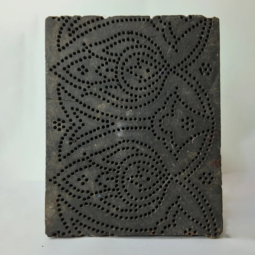 Vintage hand-carved wooden printing block with pinhole rose medallion design
