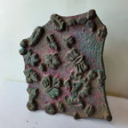 Vintage hand-carved wooden printing block with scattered leaf fan cluster design
