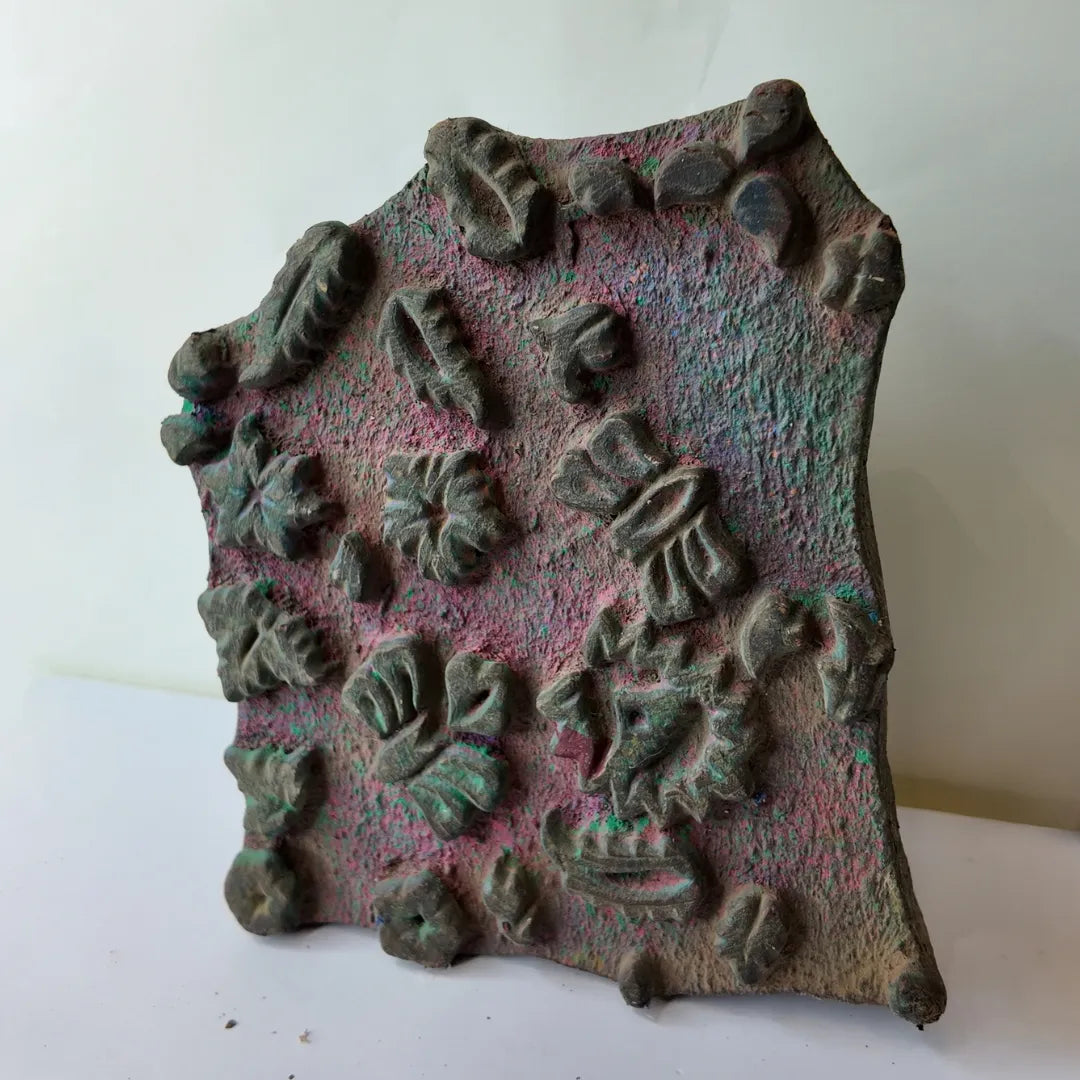 Vintage hand-carved wooden printing block with scattered leaf fan cluster design
