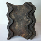 Vintage hand-carved wooden printing block with wavy ribbon groove design
