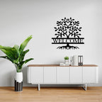 Welcome tree metal wall art above white cabinet with plant