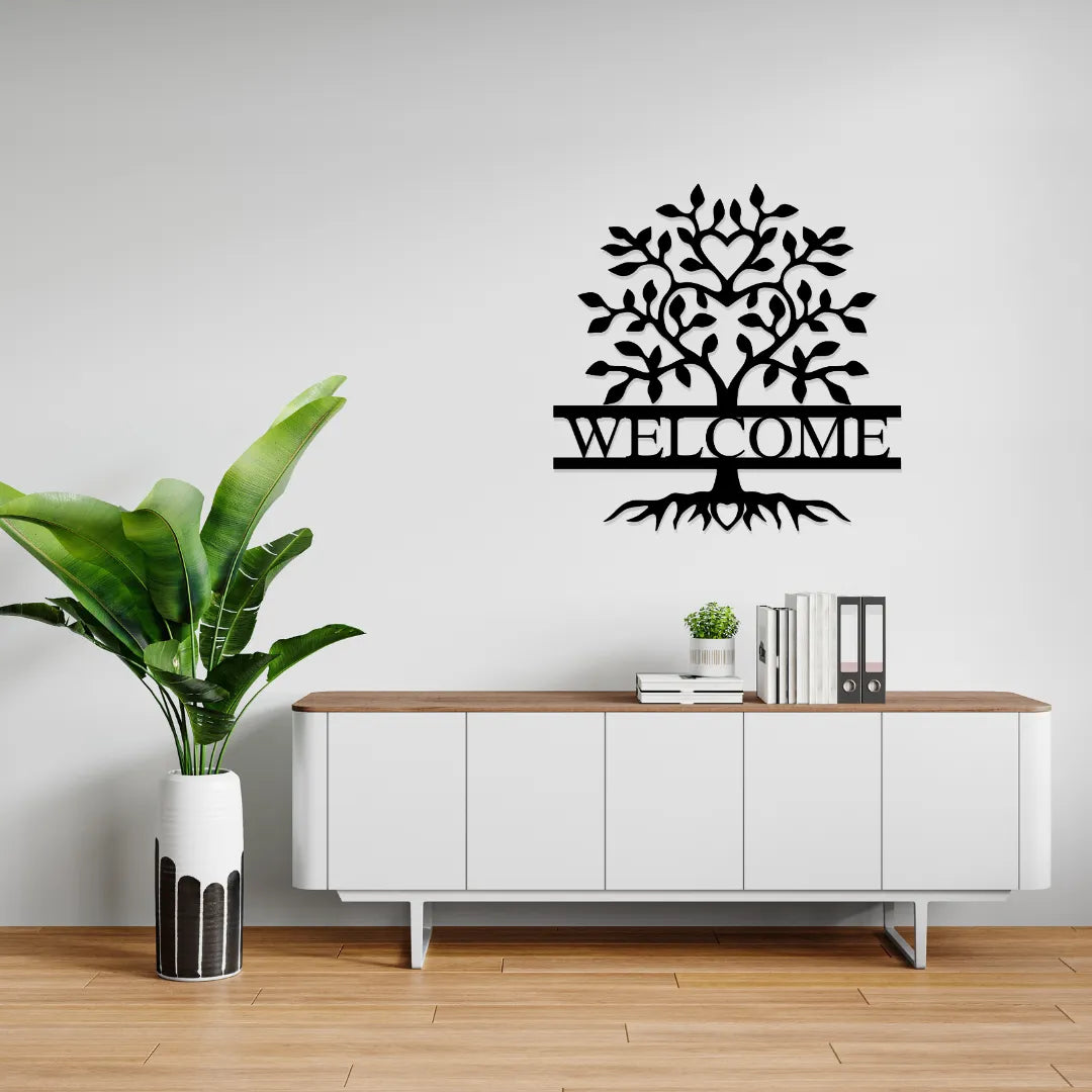 Welcome tree metal wall art above white cabinet with plant