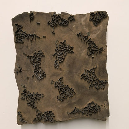 Rustic Indian wooden printing block with hand-carved abstract foliage and wave-like pattern