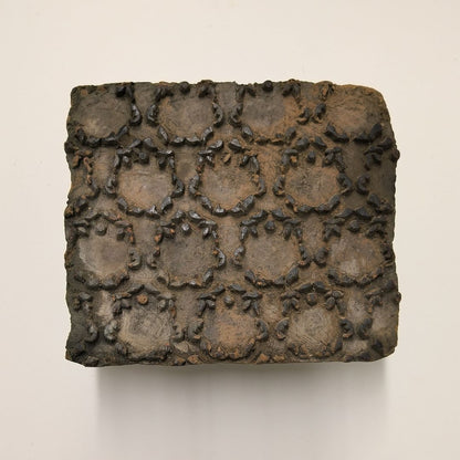Vintage wooden stamp block with ornate circular floral frame pattern