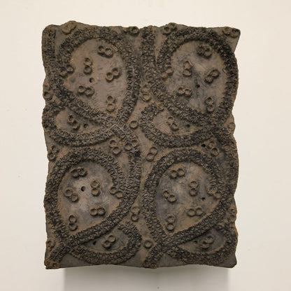 Rustic wooden block for printing with traditional paisley motif hand-carved