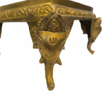 Close-up of carved brass Ganesha idol decorative stand with intricate detailing