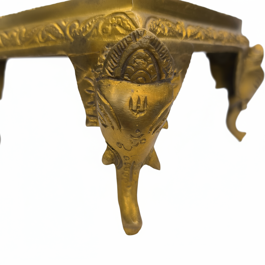 Close-up of carved brass Ganesha idol decorative stand with intricate detailing