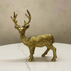 Front view of a regal standing brass deer statue with large antlers, finished in antique gold